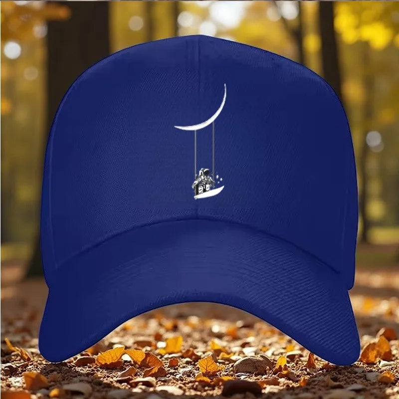 Astronaut Swinging on Moon Graphic Baseball Cap