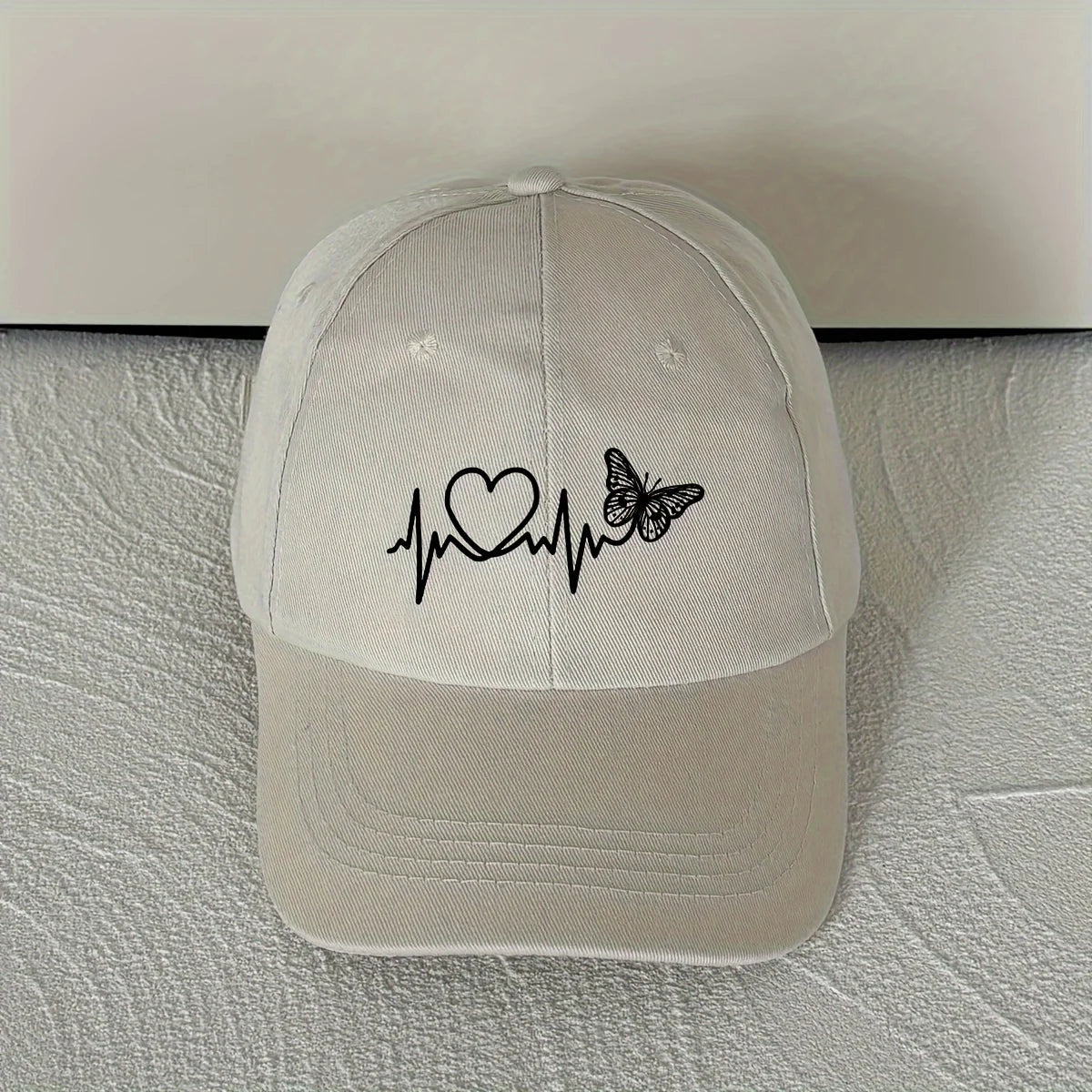 A Minimalist Baseball Cap With White Butterfly Heartbeat Print Design