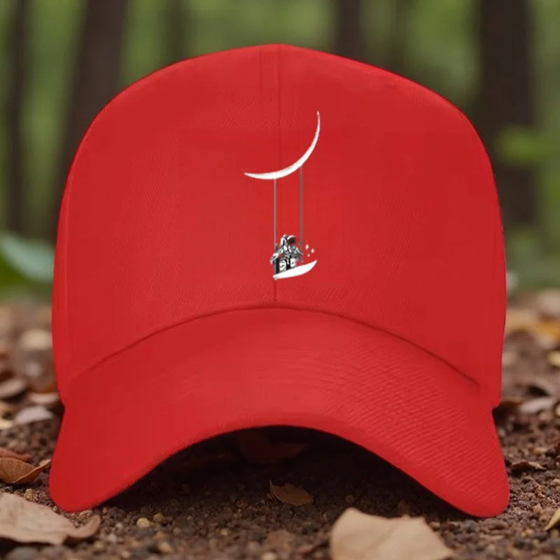 Astronaut Swinging on Moon Graphic Baseball Cap