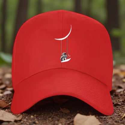 Astronaut Swinging on Moon Graphic Baseball Cap