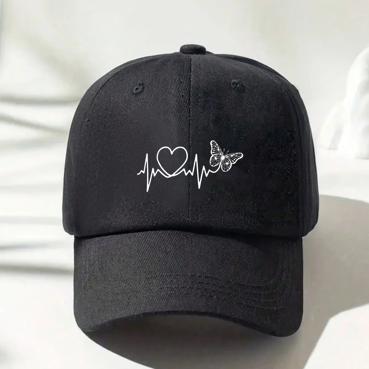 A Minimalist Baseball Cap With White Butterfly Heartbeat Print Design
