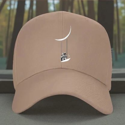 Astronaut Swinging on Moon Graphic Baseball Cap