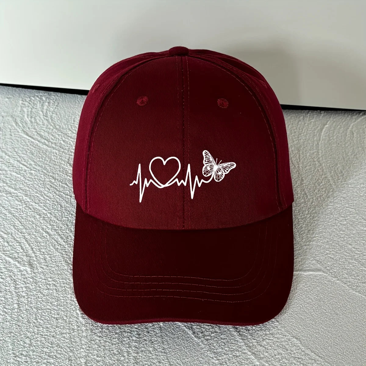A Minimalist Baseball Cap With White Butterfly Heartbeat Print Design